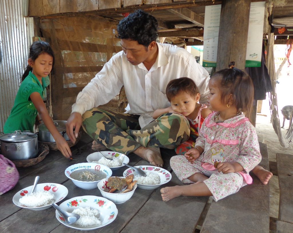 A family with small children sharing a meal with fish