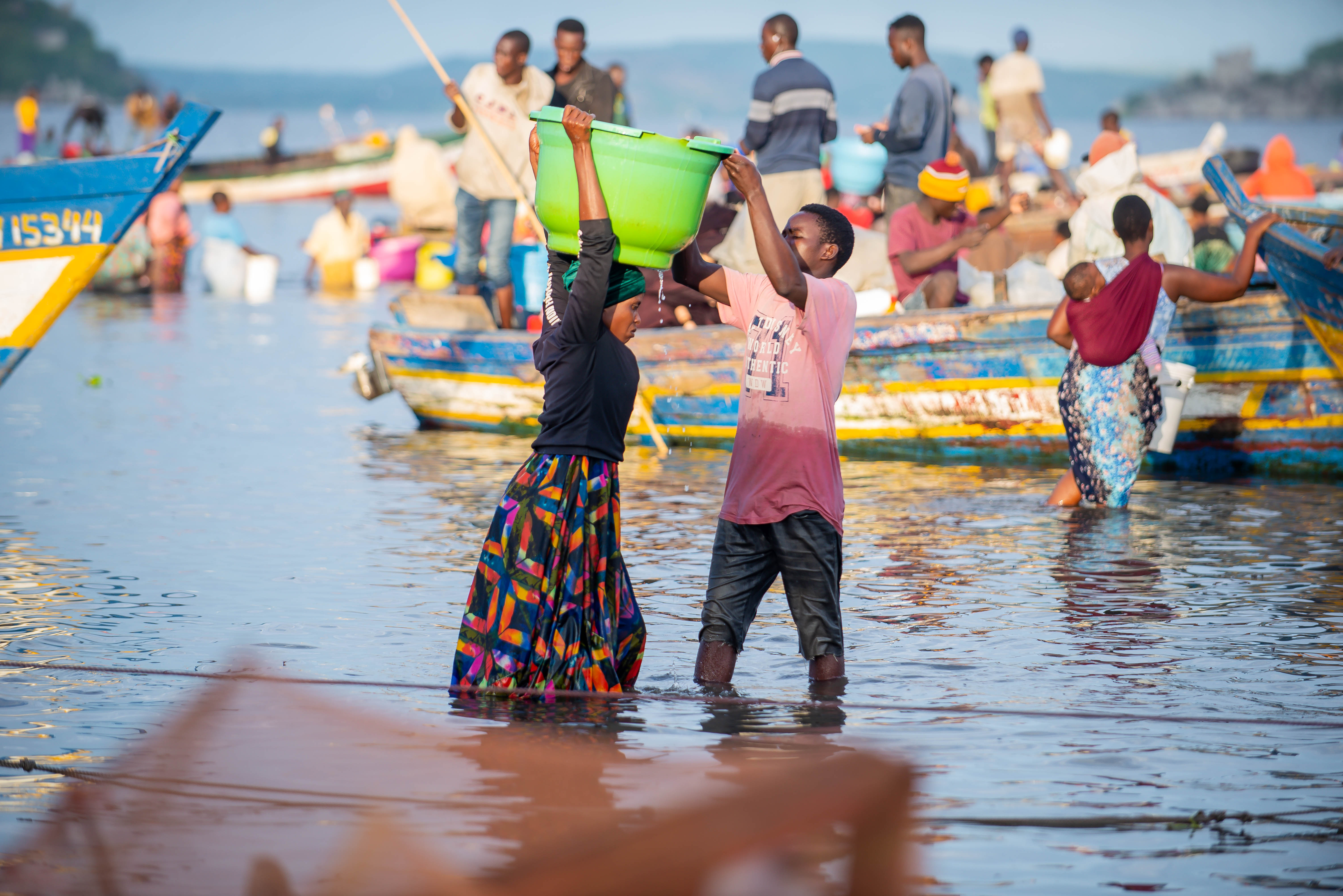 A woman carrying fish from the lake