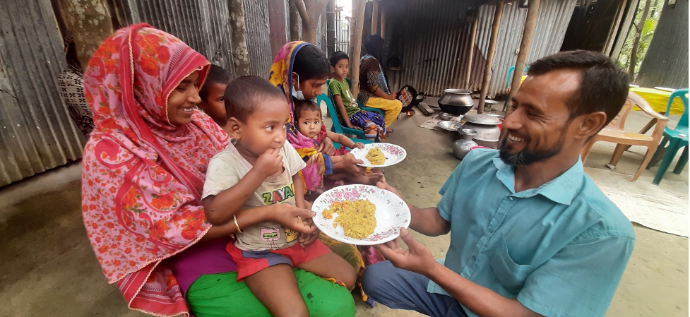 The cooking demonstrator, Mohammad Delowar, served meals to children first. Photo by WorldFish/Maherin Ahmed