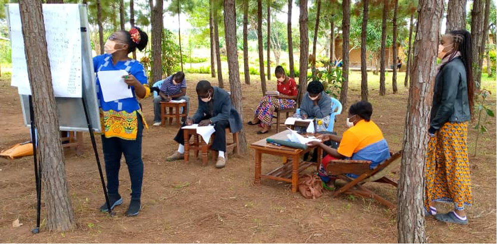 Participants writing up a section of their business plans during a training session in Mbala, Zambia. Photo by Chrispin Chikani.